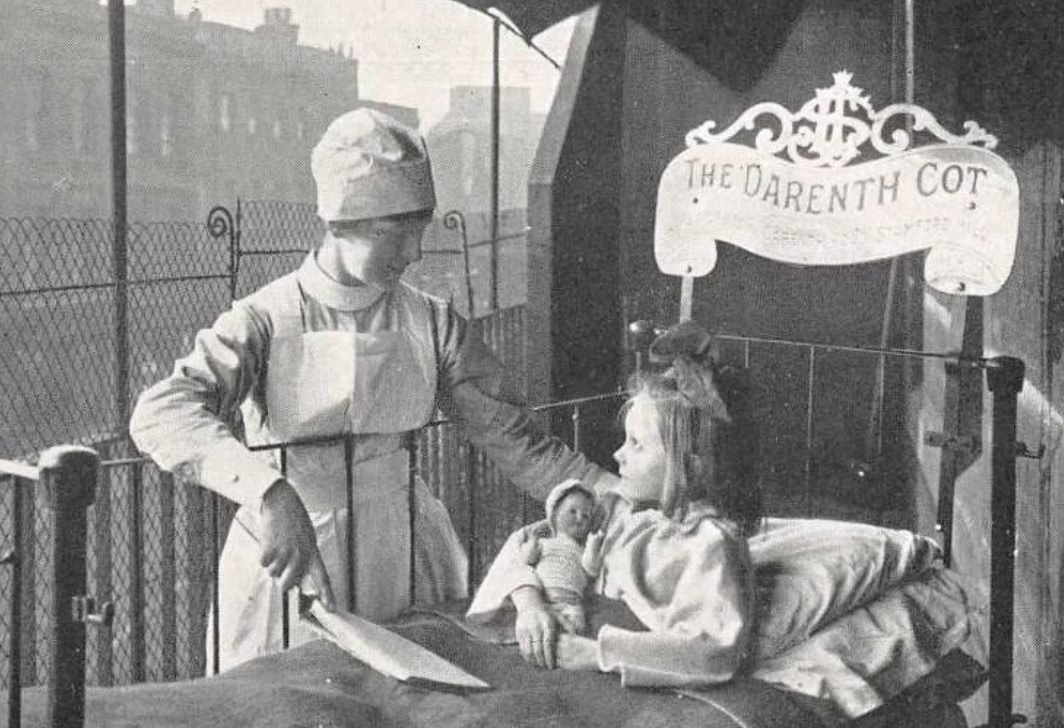 child on hospital balcony showing plaque attached to cot showing 'The Darenth Cot
